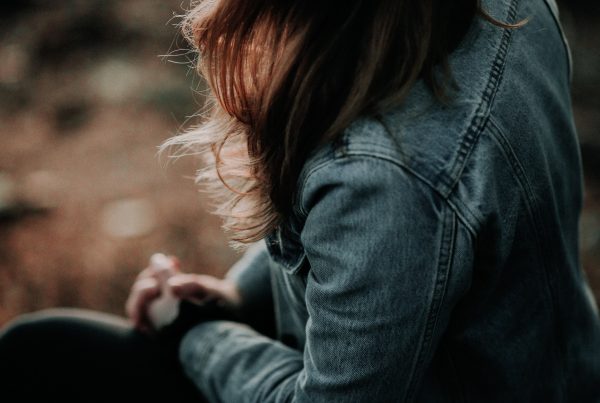 shallow focus photo of woman in blue denim jacket