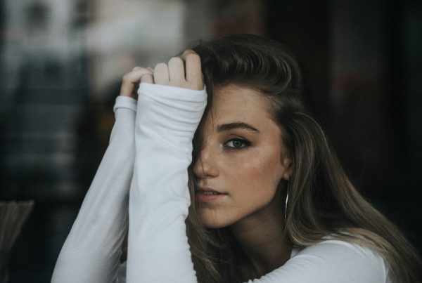 selective focus photography of woman resting hands on table