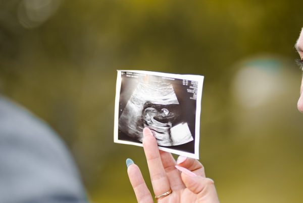 person holding picture of woman